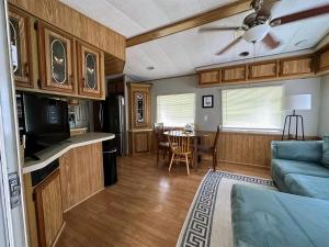 a kitchen and living room with a couch and a table at 15 min to Disney World, Self-check-in, Full Kitchen in Kissimmee