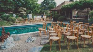 a row of chairs and tables next to a pool at Dipper star in Thoiry