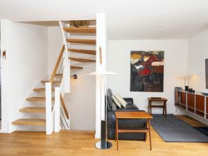 een woonkamer met een trap en een bank bij Holiday home Grenaa XLIX in Grenå