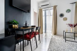 a dining room with a black table and chairs at CityHeart Studio in Bucharest