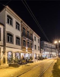a city street at night with a building at Romantic Douro River & Sunset views in Porto