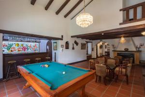 a room with a pool table and a dining room at San Jose de Puembo Quito Airport, an Ascend Collection Hotel in Puembo