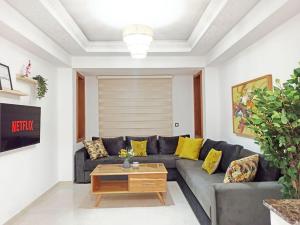 a living room with a couch and a coffee table at Hamza Boho Oasis in Essaouira