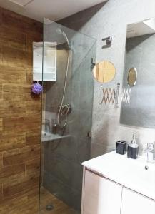 a bathroom with a glass shower with a sink at Hamza Boho Oasis in Essaouira