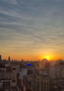 una vista de una ciudad con la puesta de sol en el fondo en Obelisco Sunset Apart 820 en Buenos Aires