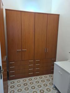 a large closet with wooden cabinets in a room at Corte Averaldo in San Felice del Benaco
