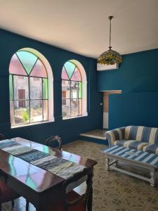 a living room with a table and two windows at Corte Averaldo in San Felice del Benaco