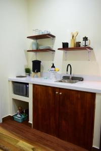 a kitchen with a sink and a counter top at Amazing House in Flores