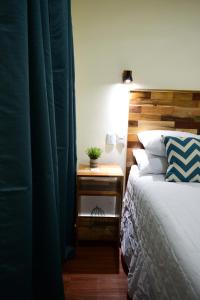 a bedroom with a bed and a nightstand next to a bed sidx sidx sidx at Amazing House in Flores