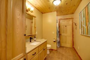 a bathroom with a toilet and a sink and a mirror at Pokegama Lake Vacation Rental with Shared Boat Dock! in Grand Rapids +26 photos