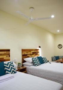 a bedroom with two beds and a ceiling fan at Amazing House in Flores