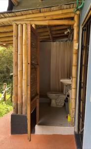 Baño con aseo bajo una estructura de madera en Alojamiento Rural - La Perla, en Filandia