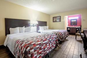 a hotel room with two beds and a mirror at Baymont by Wyndham Kingman in Kingman