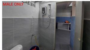 a bathroom with a shower and a toilet in it at Roomstay Fiq in Kulim