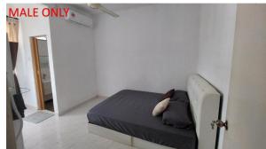 a bedroom with a bed in a white room at Roomstay Fiq in Kulim