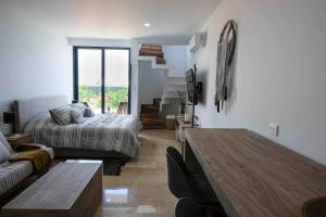 a living room with a bed and a table at Stayon5a Av penthouse with PrivatePool in Playa del Carmen +27 photos