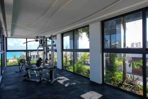 a gym with a treadmill and large windows at Stayon5a Av penthouse with PrivatePool in Playa del Carmen