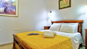 a bedroom with a large bed with a yellow blanket at Villa Vivere in Corfu Town +45 photos