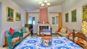a living room with a table and a fireplace at Villa Vivere in Corfu Town