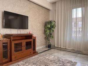 a living room with a flat screen tv on the wall at Bright and spacious 2bdr apt للعائلات Nasr city heart in Cairo