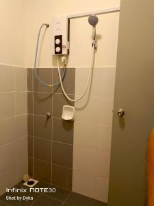 a shower with a shower head in a bathroom at DAN'S Homestay Business Suite Home in Kota Tinggi