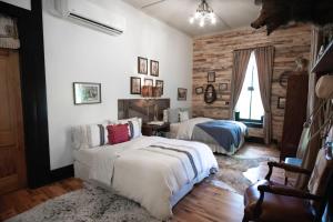 a bedroom with two beds and a couch at Beard and Lady Inn in Chester