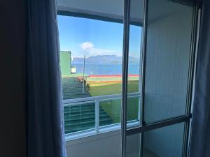 a window with a view of a baseball field at Angra inn, Angra dos Reis in Angra dos Reis