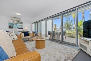 a living room with a couch and a table at Beachside Bliss 1 Bedroom Park View Villa in Mandurah