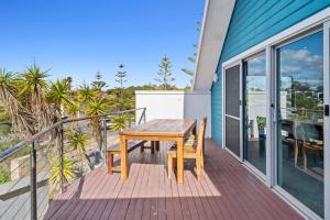 a wooden table and a bench on a deck at Beachside Bliss 2 Bedroom Family Villa in Mandurah