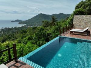 a swimming pool with a view of the ocean at Taoruna Villa in Ko Tao
