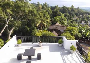 a view from the balcony of a house with trees at Shine Ray VILLA in Galle