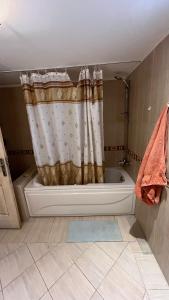 a bathroom with a shower curtain and a bath tub at Luxury large Apartment 2 bedroom all rooms with amazing sea view in Hurghada