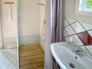 a bathroom with a shower curtain and a sink at Holiday home KARLSHAMN III in Karlshamn