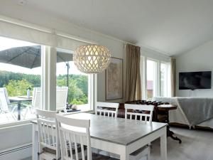 uma sala de jantar com mesa e cadeiras e uma grande janela em Holiday home Grebbestad XII em Grebbestad