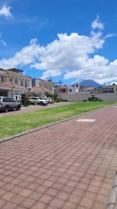 a brick walkway in a town with buildings and a sky at Casa en condominio in Quetzaltenango