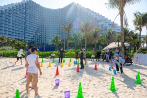 a group of people playing with cones on the beach at The Aurora Home near International Airport in Miếu Ông