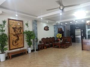 una sala de espera con mesas, sillas y un cartel en Khách Sạn Sông Hiến en Cao Bằng