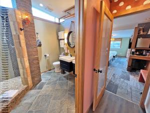 a bathroom with a shower and a toilet and a sink at Tide Pool Cabin, a Soquinomere Private Hotel on the Dunes, Downtown Ocean Shores in Ocean Shores