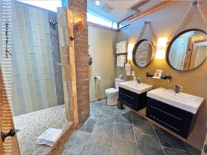a bathroom with two sinks and a shower at Tide Pool Cabin, a Soquinomere Private Hotel on the Dunes, Downtown Ocean Shores in Ocean Shores