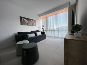 a living room with a couch and a large window at 54 Diseño Urbano in Ushuaia