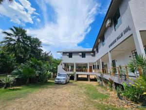 a car parked in front of a building at RIVERSIDE PALM INN SG LEMBING in Sungai Lembing