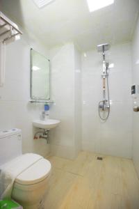 a white bathroom with a toilet and a sink at HOTEL KEIO YANGON in Rangoon Ahlone