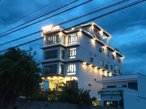 a white building with lights on it at night at HOTEL VTV DỐC LẾT in Ninh Hòa