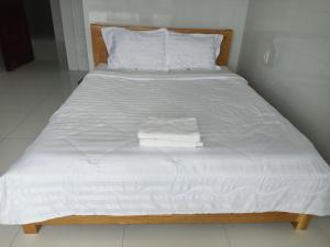a bed with white sheets and towels on it at HOTEL VTV DỐC LẾT in Ninh Hòa