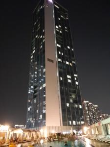 a tall building with lights in front of it at night at Songdo Halla Westernpark Hotel in Incheon