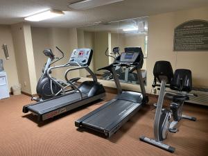 a gym with three exercise bikes and a mirror at Quality Inn & Suites in Somerset