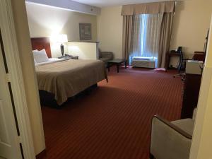 a hotel room with a bed and a window at Quality Inn & Suites in Somerset