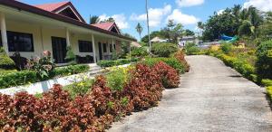 a house with a pathway leading to a garden at Bigin Garden View Resort 