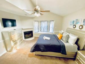 a bedroom with a large bed and a fireplace at Relaxing Oasis with Pool Gazebo in Family-Friendly Neighborhood in Montgomery