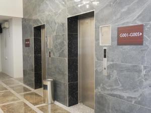 a elevator in a building with a sign on the wall at Pantai Regal City Hotel in Kuantan